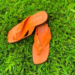 Orange leather thonged high heel by Damiani’s